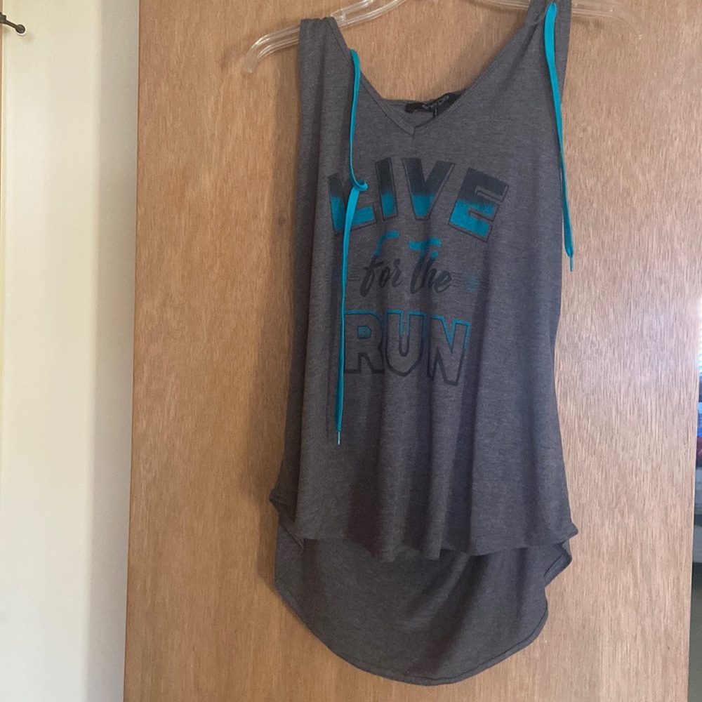 Tank top says “Live for the Run”